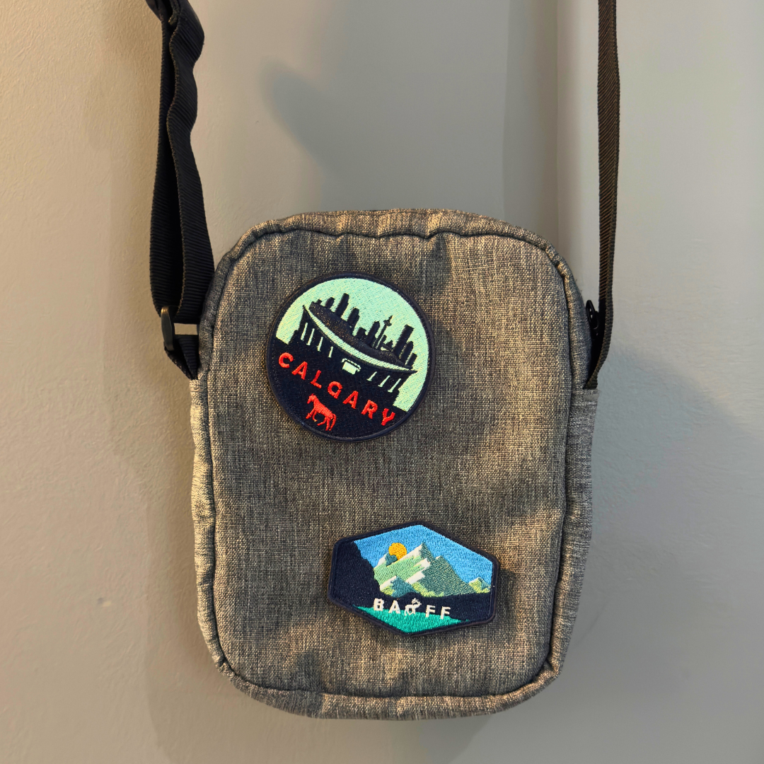 banff national park and calgary travel patch on a shoulder bag
