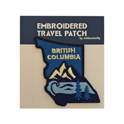Embroidered travel patch of British Columbia on a card with branding text.
