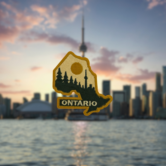 Embroidered patch of Ontario with a blurred cityscape and sunset in the background