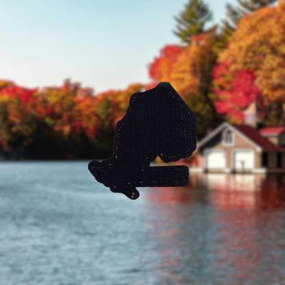 ontario travel patch with velcro with a blurred autumn landscape and cabin in the background.
