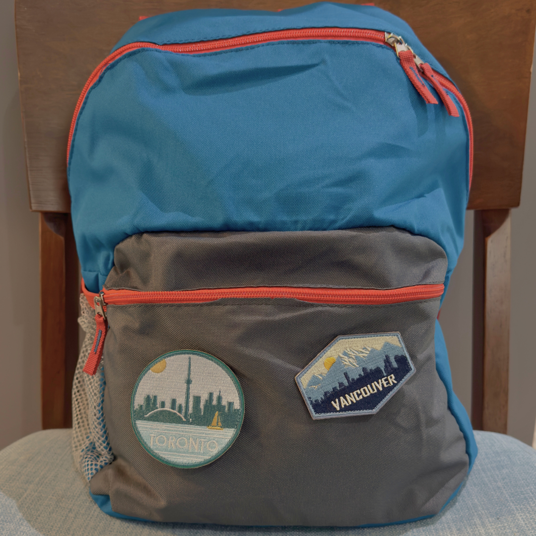 toronto and vancouver travel patch on a backpack