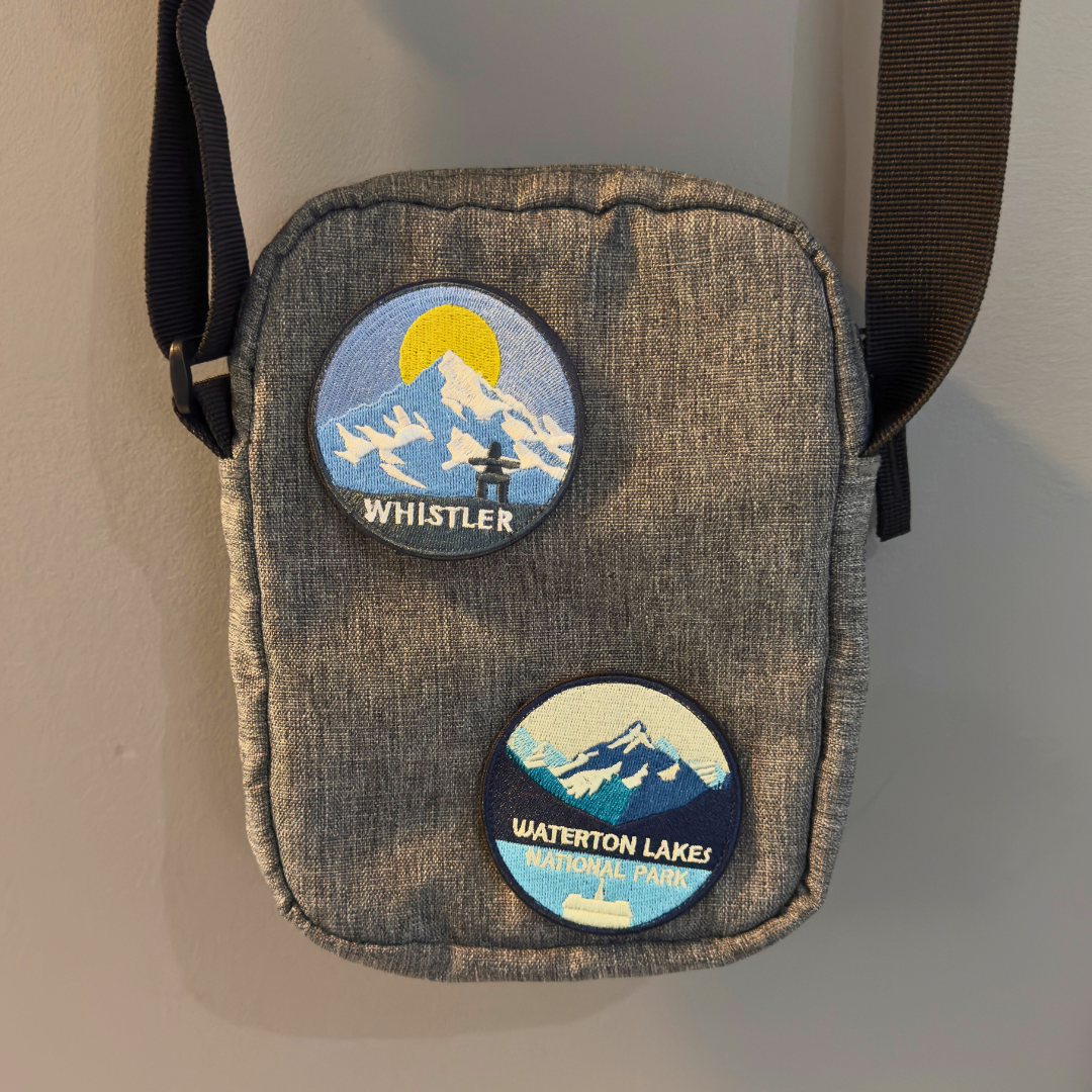 waterton national park and whistler travel patch on a shoulder bag